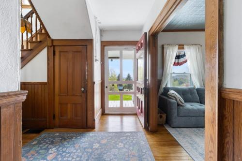 a living room with a blue couch and a door at 7PH Sunny Farmhouse Retreat, AC, Game Room, Dog Friendly in Jefferson