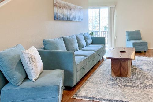 a living room with a blue couch and a table at Pikes Peak West in Flagstaff