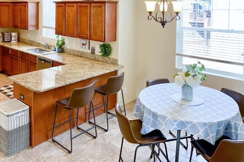 a kitchen with a table with chairs and a counter top at Pikes Peak West in Flagstaff