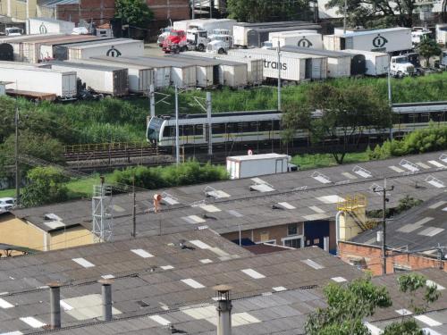an overhead view of roofs of buildings with a train at Acogedor apto in Sabaneta