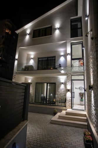 a building with lights on top of it at night at Villa Klaus Center Hotel in Tirana