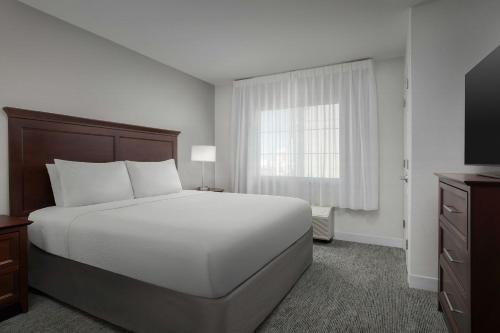 a bedroom with a large white bed and a window at TownePlace Suites El Centro in El Centro
