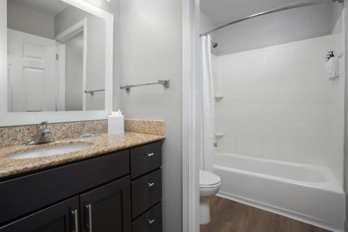 a bathroom with a sink and a toilet and a tub at TownePlace Suites El Centro in El Centro