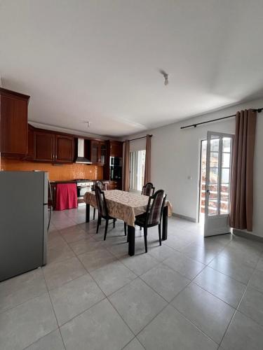 a living room with a table and chairs and a kitchen at Casa BB&Djassi - Apartment T3 in Ponta do Sol