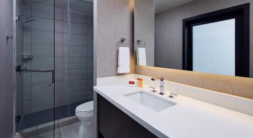 a bathroom with a sink and a toilet and a shower at The Nest Hotel Palo Alto in Palo Alto