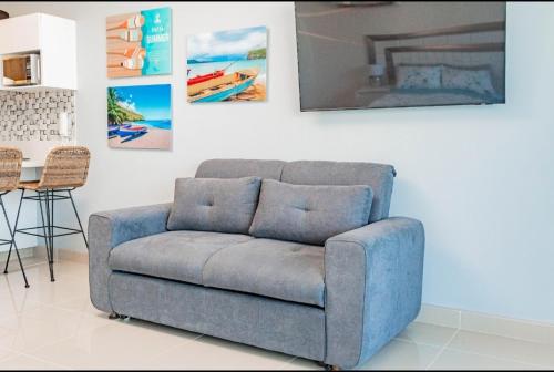 a blue couch in a living room with a table at Reserva Del Mar Apartamentos in Gaira