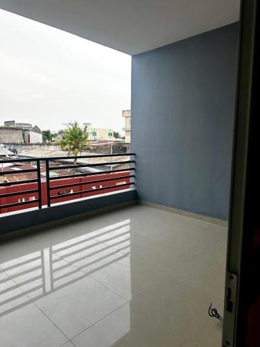 a room with a large window with a view at Private Room With Balcony, External Bathroom in Cotonou
