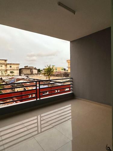 a room with a balcony with a view of a city at Private Room With Balcony, External Bathroom in Cotonou