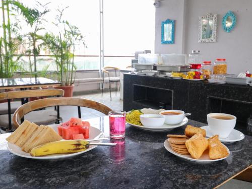 a table with two plates of food on it at Hotel Tattva Suites in Pune