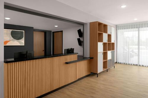 an office lobby with a reception desk and shelves at StudioRes Fort Myers in Fort Myers