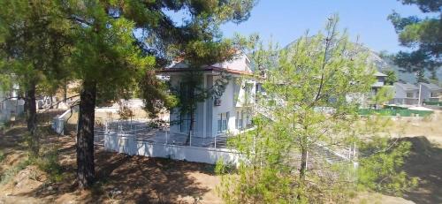 an image of a white house with trees at Villa Belce & Bloom - Üzümlü in Fethiye