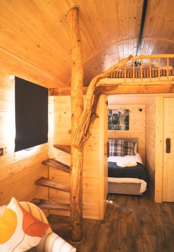 a log cabin with a bunk bed in it at Butterfly Lodge in Headcorn