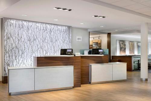 an office lobby with two reception desks and a wall at Fairfield Inn & Suites by Marriott Wentzville in Wentzville
