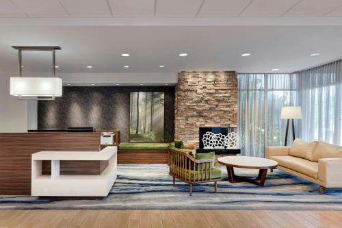 a living room with a couch and a fireplace at Fairfield Inn & Suites by Marriott Wentzville in Wentzville