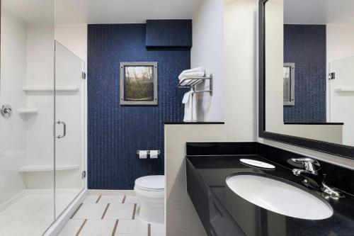 a bathroom with two sinks and a toilet at Fairfield Inn & Suites by Marriott Wentzville in Wentzville