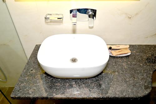 a white sink on a counter in a bathroom at JMD Royal Residency I Luxury 3-Star Hotel in Varanasi