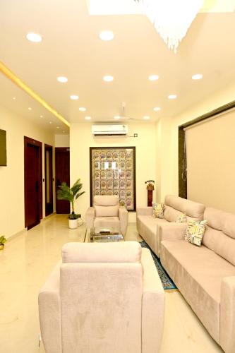 a large living room with couches and a chandelier at JMD Royal Residency I Luxury 3-Star Hotel in Varanasi