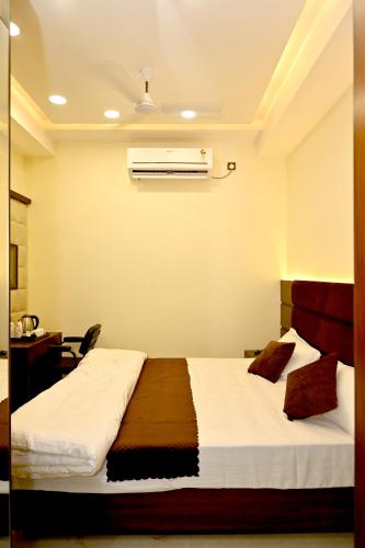 a bedroom with two beds and a air conditioner at JMD Royal Residency I Luxury 3-Star Hotel in Varanasi