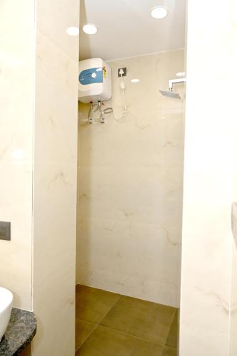 a bathroom with a shower stall and a sink at JMD Royal Residency I Luxury 3-Star Hotel in Varanasi