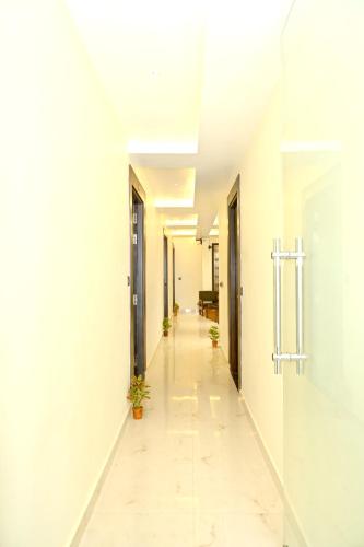 a corridor of an office building with white walls and a long hallway at JMD Royal Residency I Luxury 3-Star Hotel in Varanasi