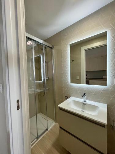 a bathroom with a sink and a shower at Dúplex Frente al Mar - Salobreña in Salobreña