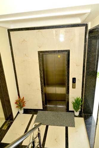 a elevator lobby in a building with plants at JMD Royal Residency I Luxury 3-Star Hotel in Varanasi