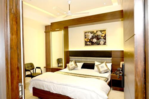 a hotel room with a bed and a mirror at JMD Royal Residency I Luxury 3-Star Hotel in Varanasi
