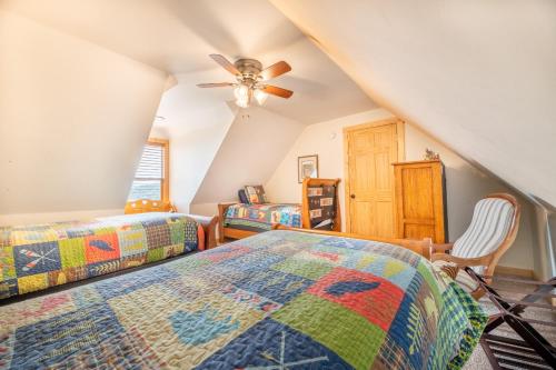 a bedroom with two beds and a ceiling fan at Endless Horizons By Avada Properties in Little Cove