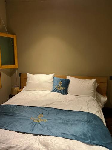 a large bed with two pillows on top of it at Yuligo Resort Skardu in Skardu