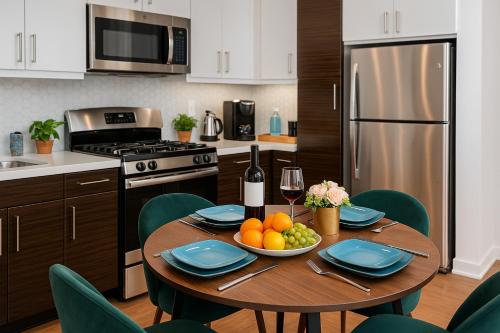 a kitchen with a table with a plate of fruit on it at High stay, new furniture apartment in Glendale