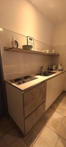 a kitchen with a sink and a stove in it at Planta Baja y Garage "Dido" Monoambiente Completo in La Cieneguita
