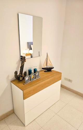 a counter with a mirror and a boat on it at Peaceful escape with private pool in Mellieħa