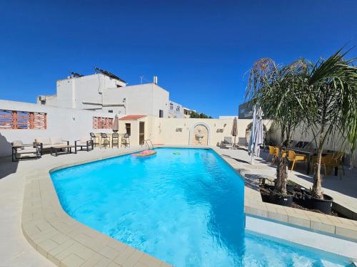 a swimming pool in front of a house at Peaceful escape with private pool in Mellieħa