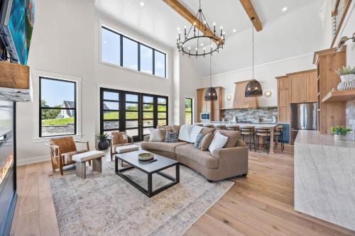 a living room with a couch and a table at NEW Spacious Clarkson Getaway w Games & Yard in Clarkson