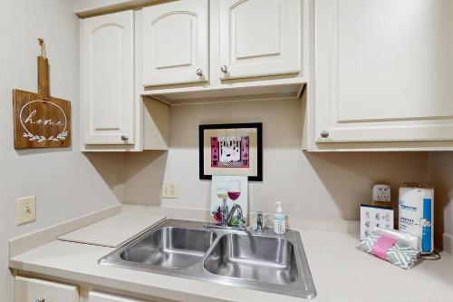 a kitchen with a sink and white cabinets at Windward Village 109 in Hilton Head Island