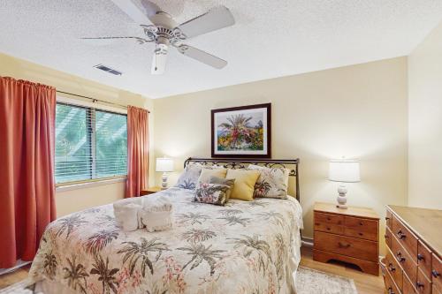 a bedroom with a bed and a ceiling fan at Windward Village 109 in Hilton Head Island