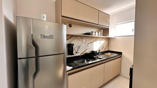 a stainless steel refrigerator in a small kitchen at Dona Olivia Universidade in Vitória da Conquista