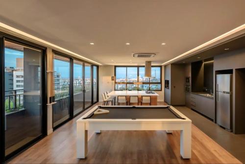 a large living room with a pool table in it at Novíssimo: Go Carlos Gomes - Infra estrutura e Vista Espetacular! in Porto Alegre