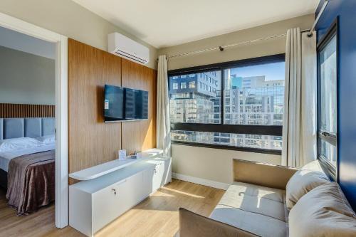 a bathroom with a sink and a large window at Novíssimo: Go Carlos Gomes - Infra estrutura e Vista Espetacular! in Porto Alegre