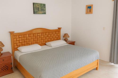 a bedroom with a bed with two pillows on it at Hotel Brisas Del Lago in Valle de Bravo