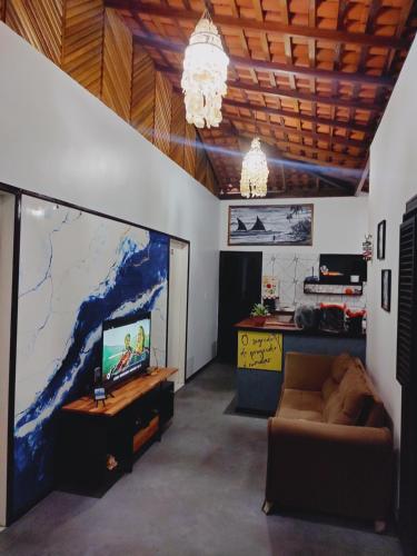 a living room with a large screen with a couch at Garden House - Atins in Atins
