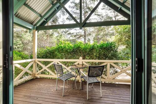 a patio with chairs and a table on a deck at Heritage Trail Lodge in Margaret River Town