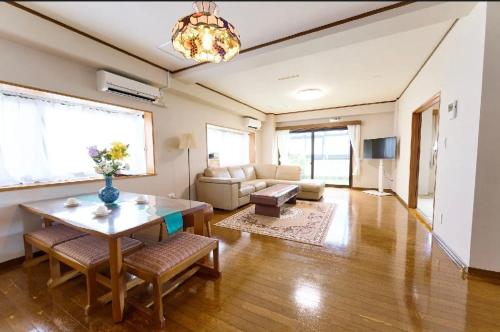 a living room with a table and a couch at Sakura house in Tokyo
