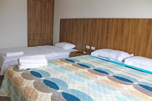 a hotel room with two beds with towels on them at Terramar Hoteles in Crucita