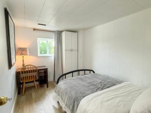 a bedroom with a bed and a desk and a window at Private Cozy 2bdrm Sleep5pp Metrotown! Free Parking! Self Check-in! in Burnaby