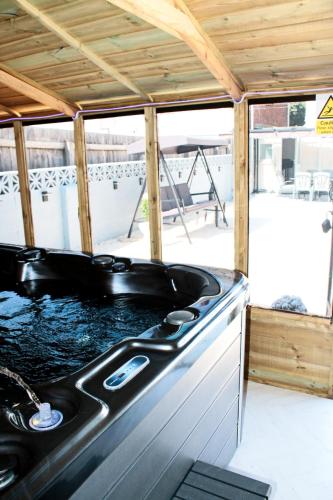 a kitchen with a stove top in a house at Cardiff - Sleep 7- Hot tub, Sauna in Cardiff