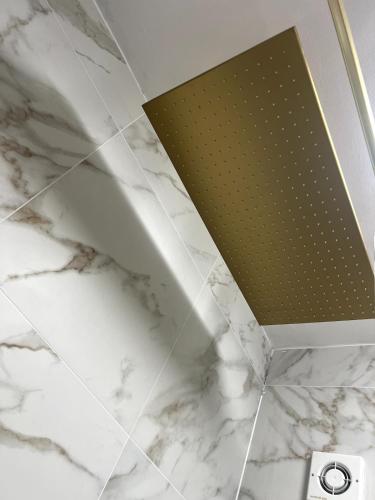 a ceiling in a bathroom with white marble at Cardiff - Sleep 7- Hot tub, Sauna in Cardiff