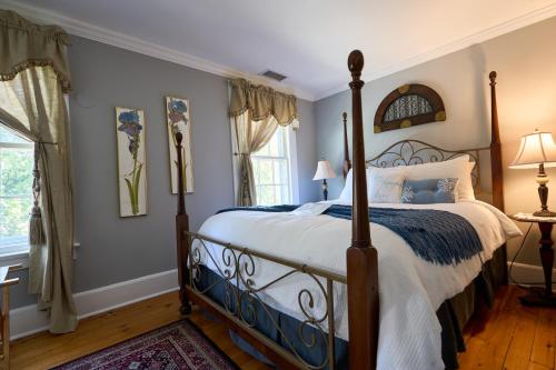 a bedroom with a bed and a window at Scranton Seahorse Inn in Madison