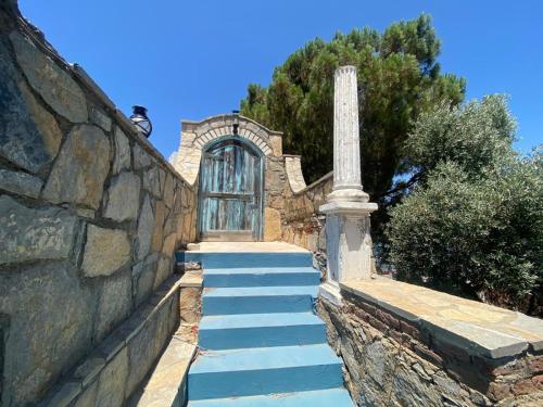 a house with blue stairs leading to a door at Sea View Getaway 2BR Flat Walk to Shorelin in Bogazici