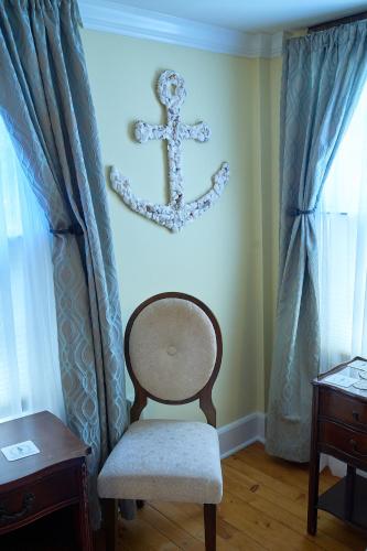 a chair in a room with a anchor on the wall at Scranton Seahorse Inn in Madison